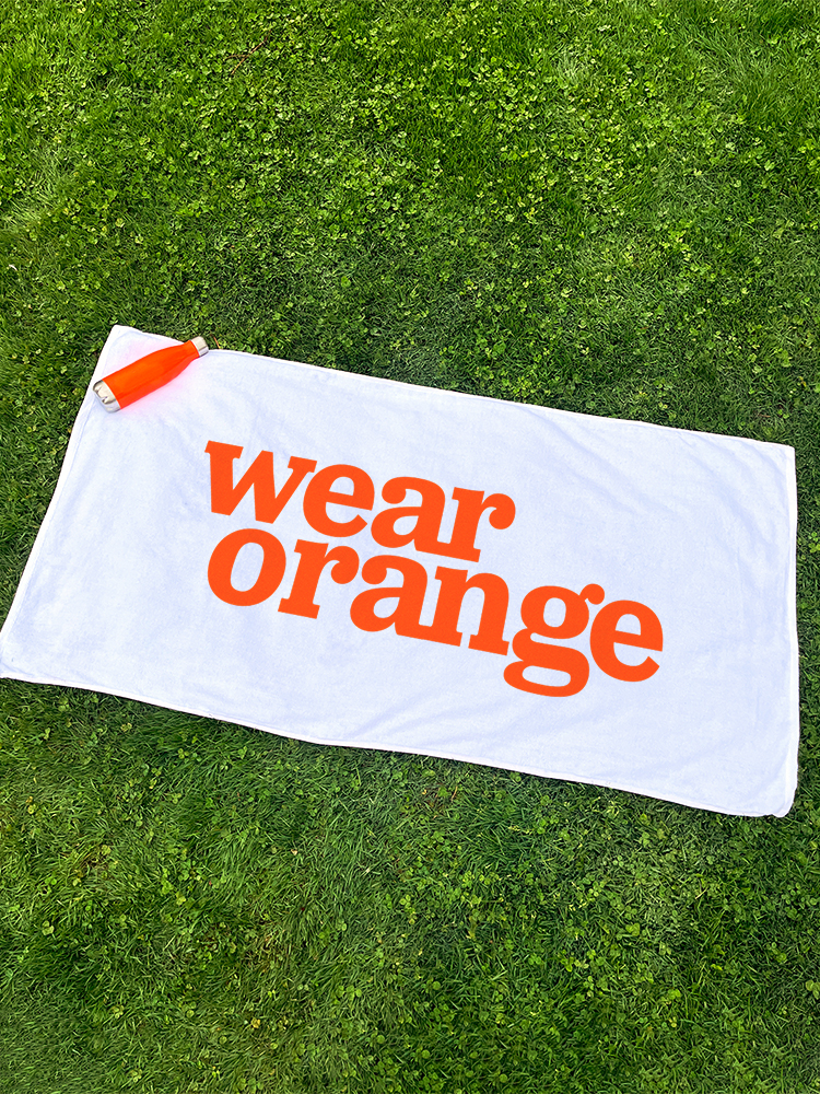 White towel with Wear Orange on it in orange text